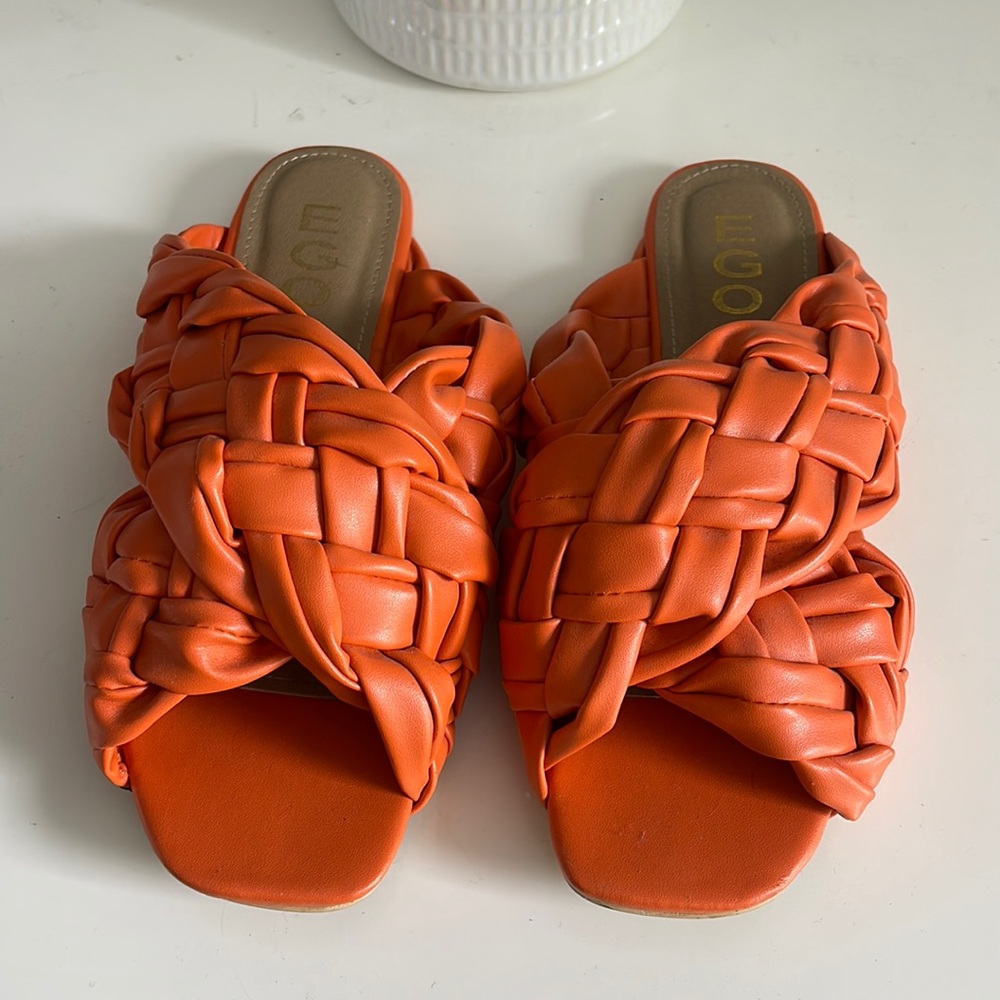 Orange sandals, lightly worn.